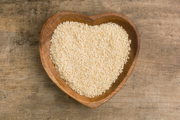 bowl with white sesame seeds on a light background