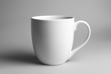 Fototapeta premium Simple white ceramic mug on a neutral gray background. Ideal for branding, coffee shop promotions, and product display mockups