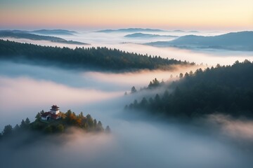 Fototapeta premium fog covers the valley below a mountain range with a house in the foreground