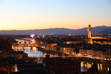 suggestive view of Florence in Tuscany Italy with the monuments at dusk with the Arno river flowing...
