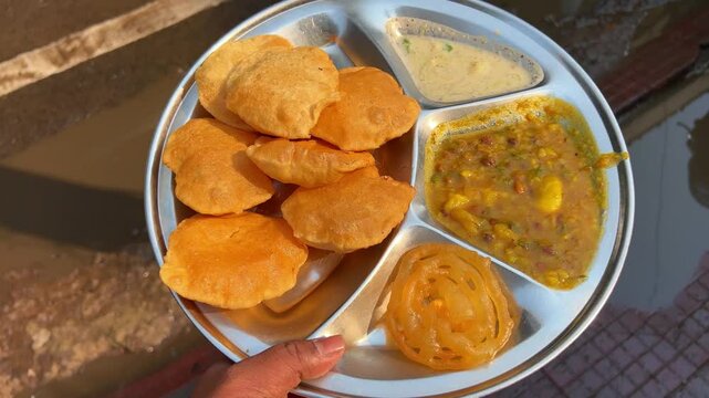 Club kachoris served with aloo sabji and chutney.