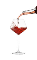Pouring wine into glass on white background