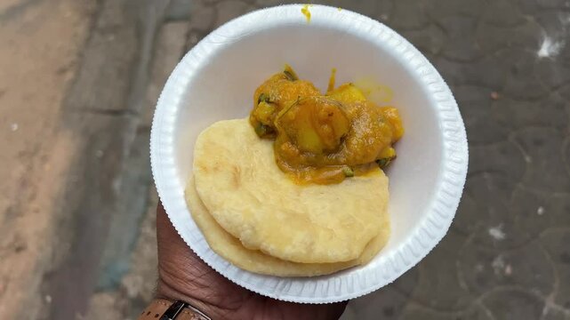 Closeup shot of maida kachoris with aloo dum in a road side stall in India