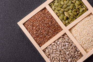 Sunflower, pumpkin, flax and sesame seeds in a wooden box