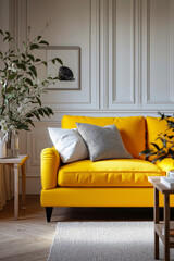 A yellow couch sitting in a living room next to a table