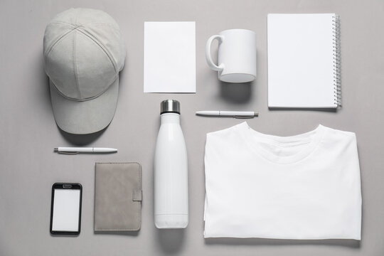 Different blank items for branding on grey background, flat lay. Mockup for design