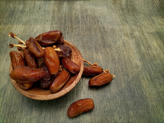 dried dates on wooden surface