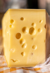 Piece of delicious emental cheese with holes