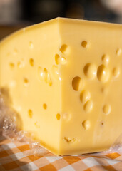 Piece of delicious emental cheese with holes