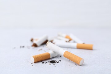 Cigarette butts on light background, selective focus
