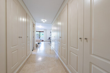 an image of white fitted wardrobes in the master bedroom of holiday home