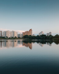 Lake Lebedyne at sunset. High rise residential buildings reflecting in the water at dusk.