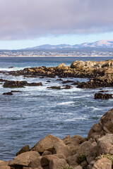 Clouds and waves in rocky beach