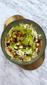 Adding hot sauce on homemade taco salad
