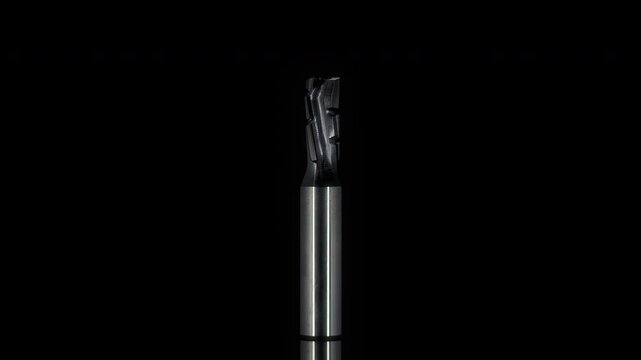 Metal milling cutter in rotary motion on a black background