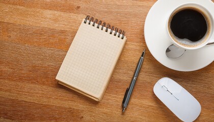 cup of coffee, notebook, pen and mouse on wooden desk