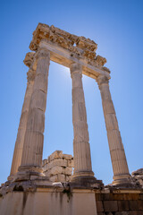 Fototapeta premium Historical view of greek antique city of Bergama. Ancient architectural landscape with marble columns and walls with a blue background. Ancient city of Pergamon. Archaeology and tourism concept backgr