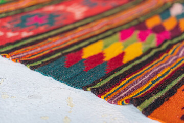 Fototapeta premium Close-up image of a vibrant, handmade textile with floral and geometric patterns