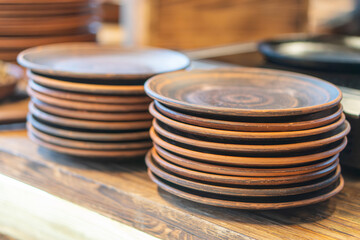 Image of wooden plates stacked on a table surface, possibly used in a restaurant setting