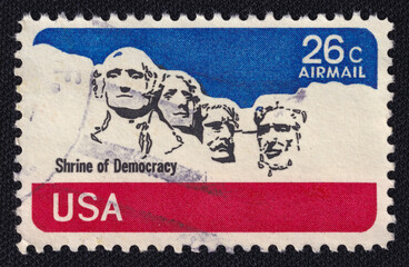 Old vintage cancelled postage stamp printed in USA circa 1974 shows presidents George Washington,...