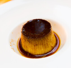 Delicious French creme dessert - flan with chocolate sauce