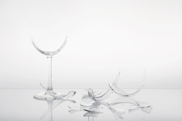 Pieces of broken wine glass on white background