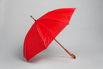 Open blank red parasol for branding on light grey background. Mockup for design © New Africa