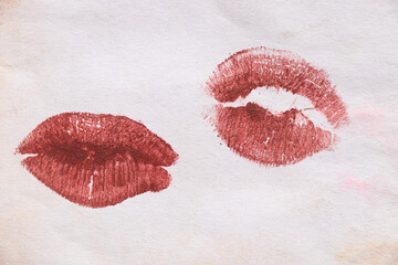Maroon lipstick kiss mark on white old paper, kiss