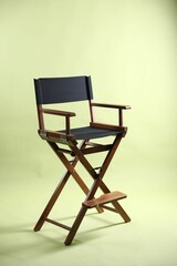 One empty director's chair on pale olive background