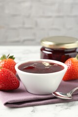 Delicious strawberry sauce and fresh berries on white marble table, closeup. Space for text