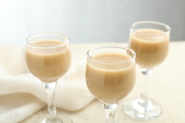 Coffee cream liqueur in glasses on table, closeup