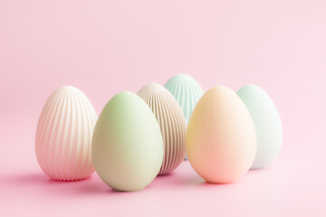 Easter decoration. Colorful eggs on pink background.