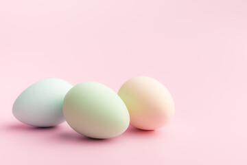 Easter decoration. Colorful eggs on pink background.