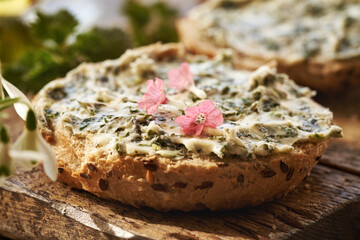 Nettle butter - homemade bread spread made of wild edible plants collected in spring, with lungwort...