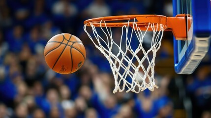 Fototapeta premium A basketball is shot through the net with a ball soaring in the air.