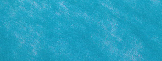 Texture blue and turquoise color felt background with spots of fabric, macro. Structure of woolen cerulean textile