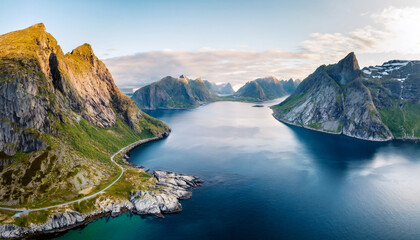 Obraz premium Majestic Norwegian Fjord Landscape: A breathtaking panorama of the iconic Norwegian fjords, featuring towering mountains, deep blue waters, and a winding coastal road that invites exploration.