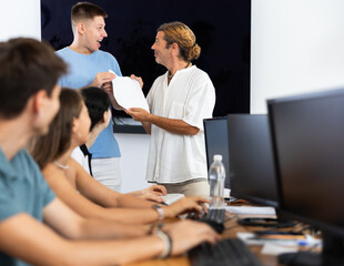 Obraz premium Teacher presents diploma to diligent student, honoring his hard work with reward