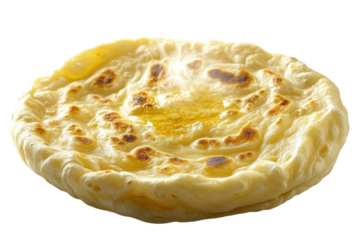 Deliciously warm naan bread topped with melted butter served in a traditional setting