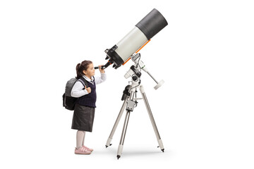 Schoolgirl in a uniform observing the sky through a telescope