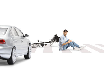 Car hitting a man with a bicycle on a street