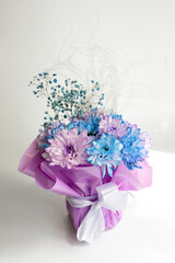 Beautiful bouquet of blue and purple flowers arranged with soft accents for decoration or gifting