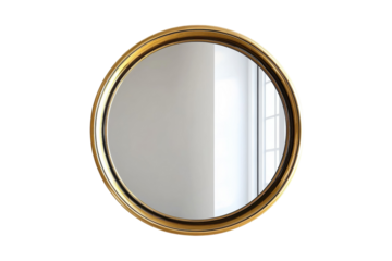 Round golden mirror reflecting a spacious room with natural light and elegant decor elements during the day