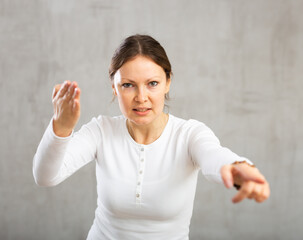 Upset woman argues with passion and frustration pointing with accusation