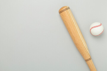 Wooden baseball bat on color background, top view