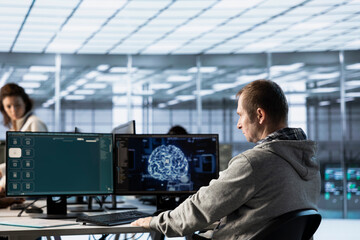 Computer scientist in data center coding AI LLM chatbo answering user prompts using predictive technology. Server room employee building large language model program using artificial intelligence