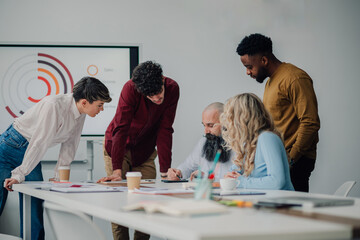 Marketing professionals working together on a project in the office