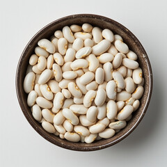 Close-up of a bowl filled with whole, raw, unpeeled pistachios against a white background.