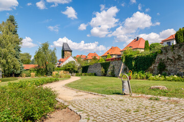 Wernigerode, Germany – August 29, 2024: Park near the remains of the Wernigerode city wall. The half-shell tower or halbschalenturm can be see. In the Middle Ages the wall included thirty towers.