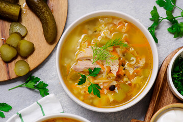 Traditional Russian rassolnik soup with pork and pickles .style rustic